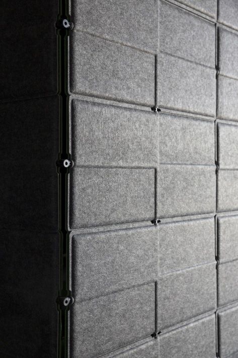 Detailaufnahme der grauen USM Haller Privacy Panels, verbunden durch Chromkugeln, für Büro und Arbeitsplatz.