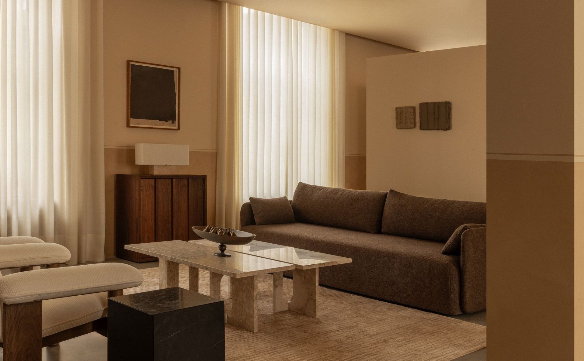 Audo Copenhagen Offset Sofa, braunes 3-Sitzer-Sofa in stilvollem Wohnzimmer mit Marmortisch und Designermöbeln.