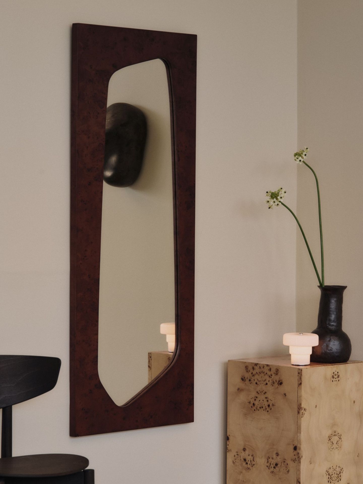 Nahaufnahme der Ripple tragbaren Tischleuchte von Ferm Living auf einem Nachttisch neben einer Vase.