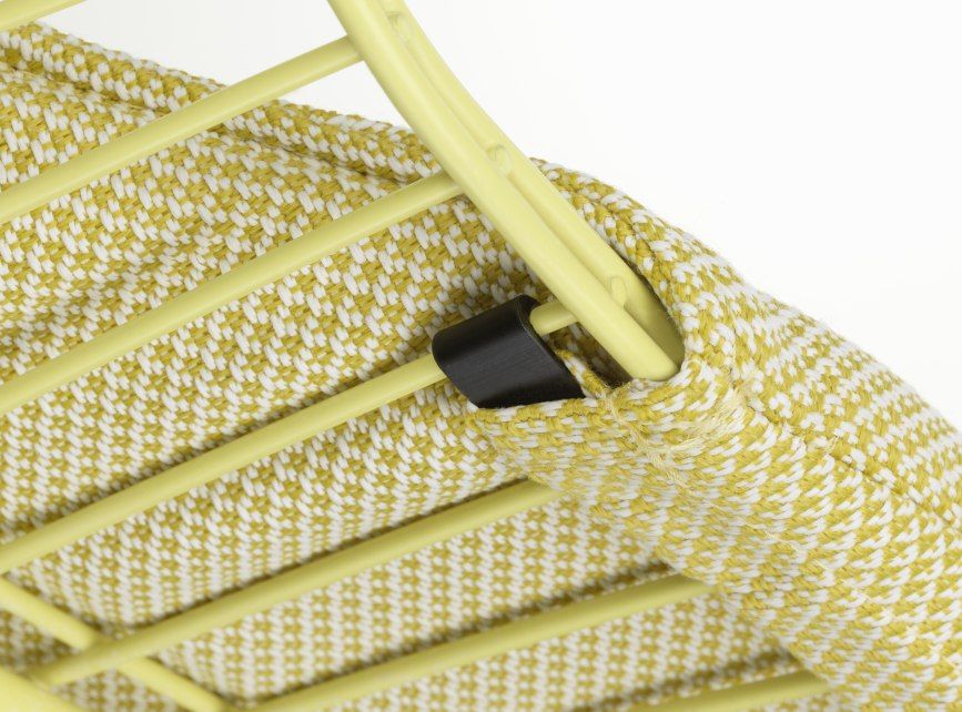 Detailaufnahme des Vitra Wire Chair Bikini Outdoor mit gelb-weiß kariertem Bezug und gelbem Drahtgestell.